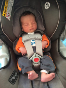 Infant properly secured in car seat